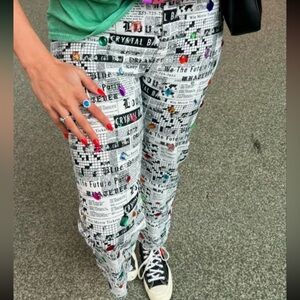 One of a kind Handmade Graphic Newspaper Print Pants with sewn on gems.